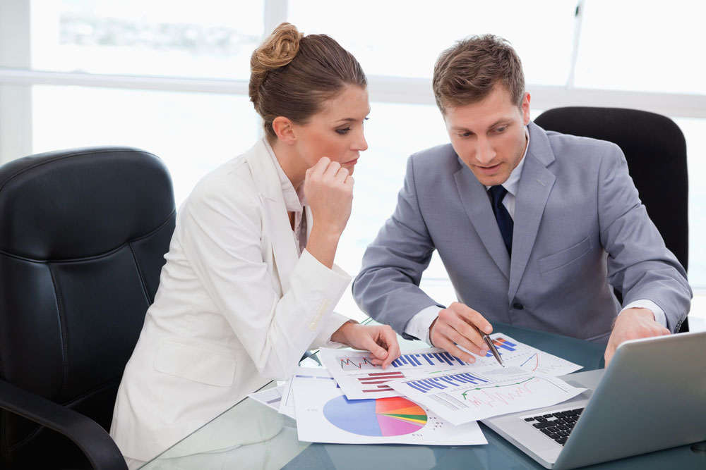 Business team analyzing market research data Business team analyzing market research data