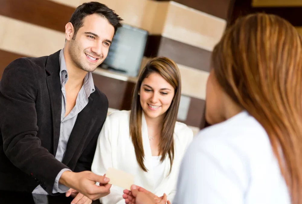 Couple on a business trip doing check in at the hotel