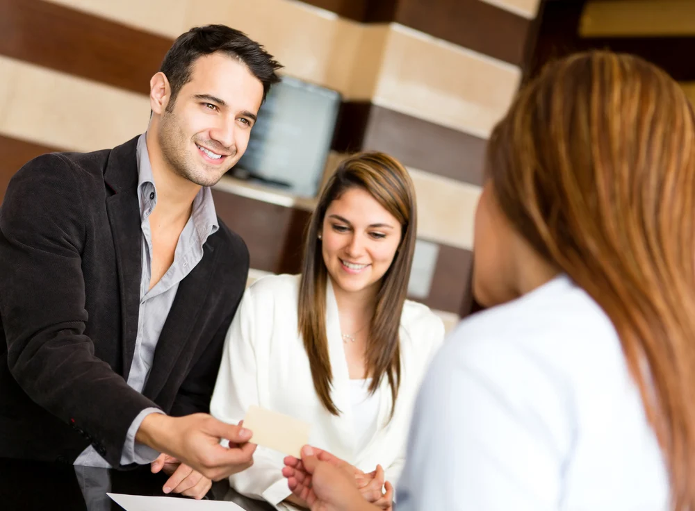 Couple on a business trip doing check in at the hotel