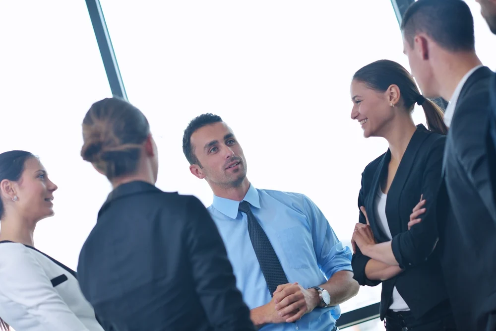 Group of happy young business people in a meeting at office