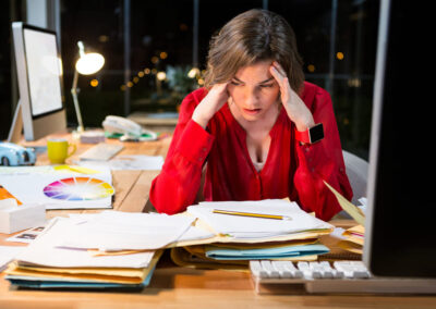 Stressed businesswoman sitting in front of computer in the office