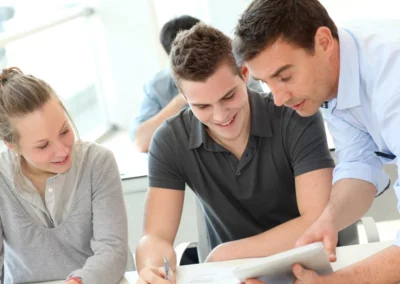 Teacher helping students with assignment