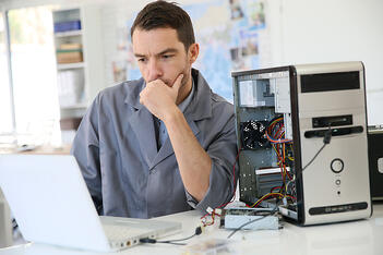 Technician fixing computer hardware