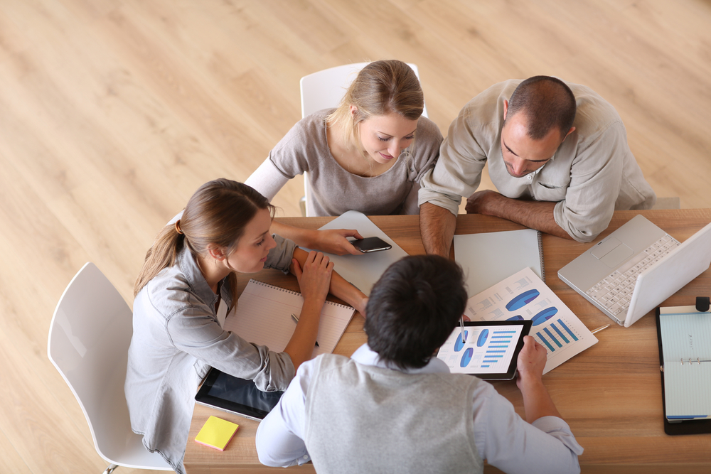 Upper view of business people around table Upper view of business people around table