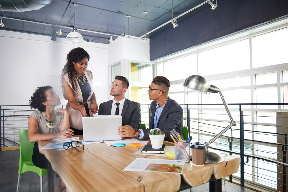 team of successful business people having a meeting in executive sunlit office team of successful business people having a meeting in executive sunlit office