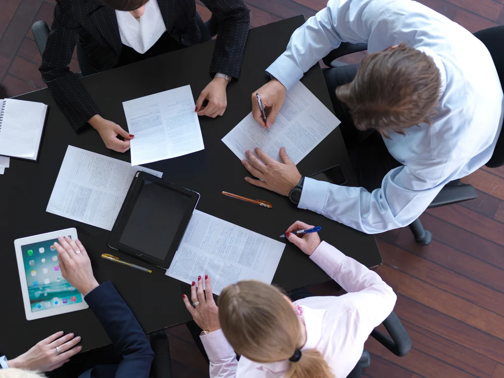 top view of business people group on meeting working in modern bright office indoor with tablet computer 1